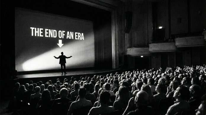 Famous presentation moments - dramatic slide illuminating a dark auditorium