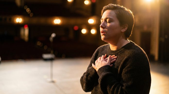 Public speaking with anxiety - person calming themselves before going on stage