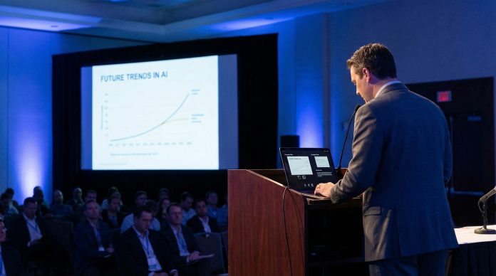 Presenter viewing speaker notes on laptop while slides show on screen